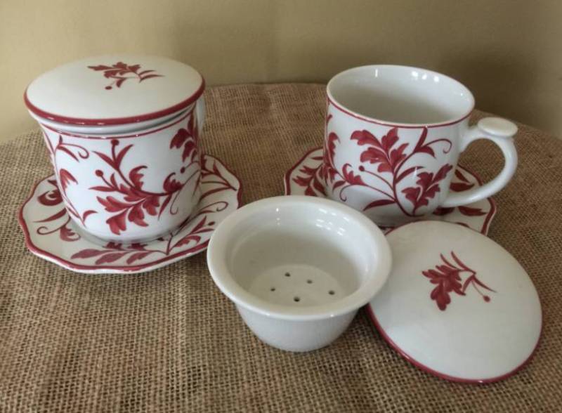lot 1120 image: Set of red and white tea cups (made for loose tea brewing) with saucers