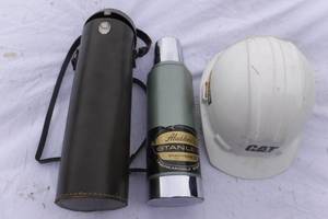 lot 6996 image: Aladdins Stanley Thermos and CAT Hardhat