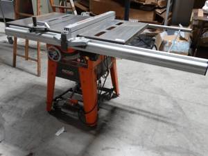lot 2311 image: Awesome Ridgid 10 table saw w stand- Nice looking unit-