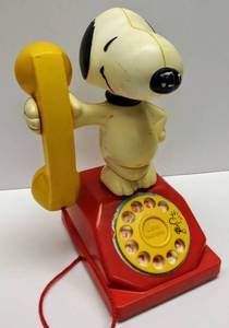 lot 104 image: 1966 Peanuts Snoopy Toy Telephone  Rotary Phone Spins