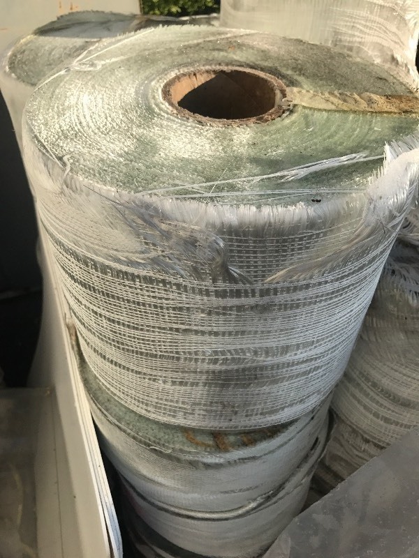 lot 228 image: Large roll of fiberglass fabric estimated 12 inches wide by 300 feet long could be longer