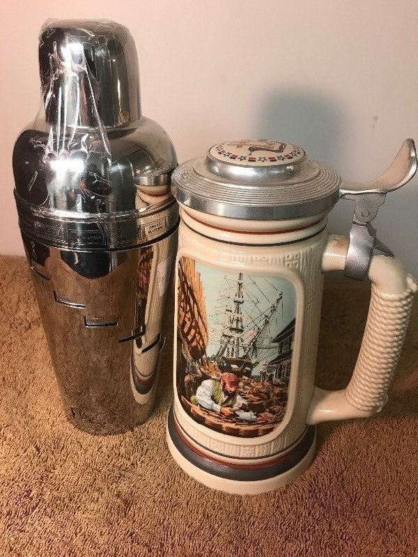 lot 60 image: Two nice bar items ceramic stein and liquor shaker with built-in recipe maker