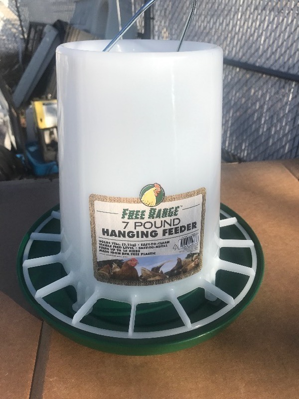 lot 80001 image: New 7 pound chicken feeder as pictured great for your new chicken coop in your backyard