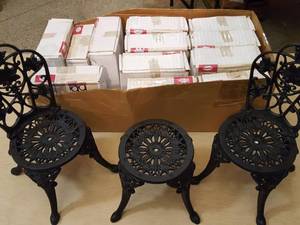 lot 41 image: cast iron doll furniture, 8 chairs, four tables. All pieces unassembled in boxes assembled pieces are for display purposes only