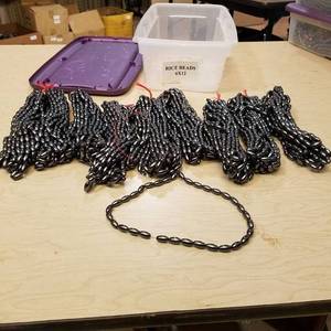 lot 122 image: Approximately 90 strands of 6 by 12 mm rice beads