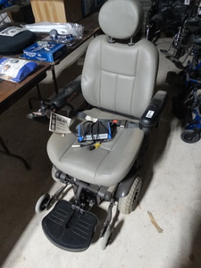 lot 7997 image: Pride mobility electric wheelchair- New w tags- Retail-$5400