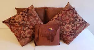 lot 4197 image: Lot of 5 Accent Pillows - 4 Half Brown Suede LeatherHalf Reddish Colored Upholstery Material (17 in square)and 1 Leather Square (13 in.) with Bear Embroidery
