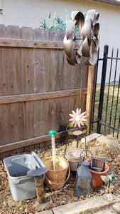lot 4221 image: Lot of Outdoor Decor - Metal Whirling Jig (6 ft. tall - pole needs repaired), Bird Feeders with Tote of Seed, Rain Gauge, PotsBucket, and More