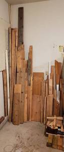 lot 4238 image: Lot of Wood Boards (Various TypesSizes - Longest Board is about 10 ft.), PVC Pipe, and Open Metal Coated Shelf Piece