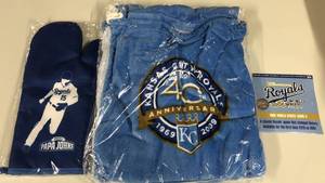 lot 1076 image: Three Kansas City Royals Stadium Giveaways - 1985 World Series CD, 40th Anniversary Towel, & Whit Merrifield Oven Mitt Whit Mitt