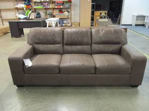 lot 3 image: Brown Sofa....has shipping damage on one side along the bottom and on one edge