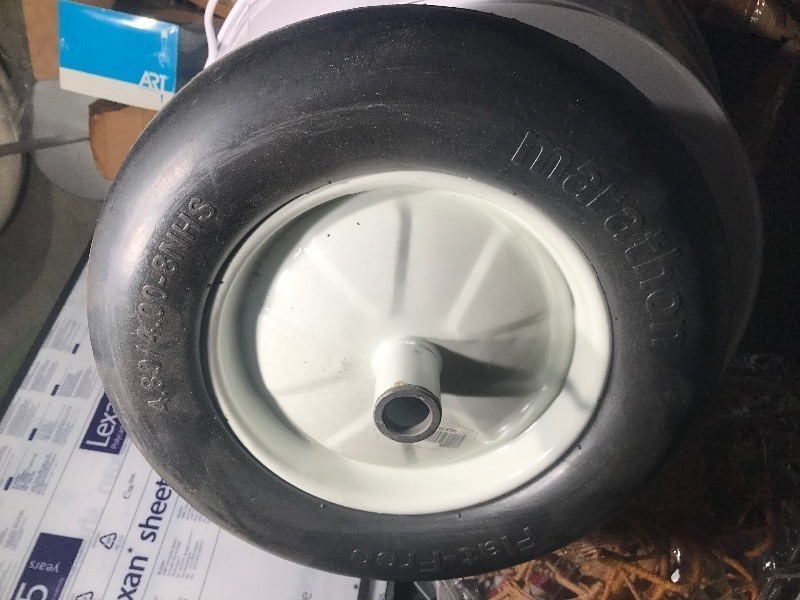lot 812 image: New no flat wheel barrel style tire and wheel or use on other work items see picture for size