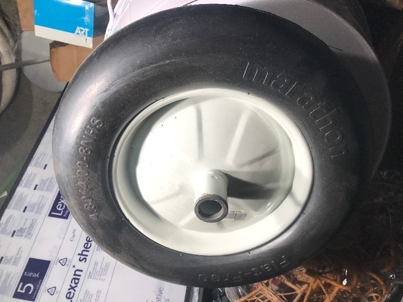 lot 813 image: New no flat wheel barrel style tire and wheel or use on other work items see picture for size