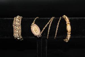 lot 2605 image: Vintage Jewelry Set Including Locket Necklace (perfume or lip gloss) and 2 Gold Metal Bracelets and Hoop Earrings