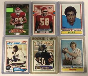 lot 1061 image: Lot of Six Stars & Hall of Famer Rookie Cards - Lawrence Taylor, Singletary, Spurrier, Derrick Thomas, Tony Gonzalez, and Ahmad Rashad