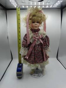 lot 9016 image: 16 heritage mint bisque porcelain doll with a pink dress and ribbon in her hair