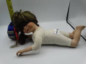 lot 9019 image: approximately 1ft porcelain doll with broken right foot