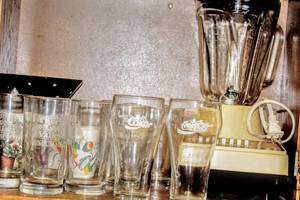 lot 3164 image: Vintage Hamilton Beach 14 Speed Blender, Assorted Glasswares including Coka Cola Glasses, Mugs, Apple Farm, and more