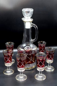 lot 3127 image: Beautiful Art Glass Decanter and 6 Stemmed Liqueur Glasses, Gold trimmed and Red with Cut Glass Details