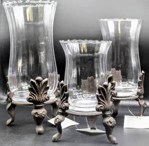 lot 3416 image: 12, 10, 9 Glass Candle Holders on Metal Fleur De Lis Design Stands