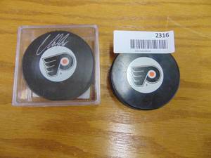 lot 2316 image: Pair of Philadelphia Flyer Hockey Pucks, 1 is Autographed by Claude Giroux