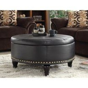 lot 43600 image: INSPIRED by Bassett Augusta Eco Leather Round Storage Ottoman with Brass Color Nail Head Trim and Deep Espresso Legs, Grey