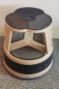 lot 6053 image: Vintage Tan Metal Kik Step Stool on Casters  14 in. tall
