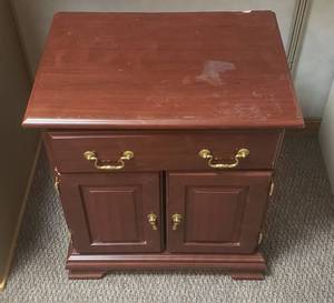 lot 6077 image: Sauder Cherry Pressed Wood Side Cabinet w Single Drawer  Slight Damage on Top  24 in. x 17 in. x 27 in.