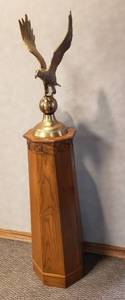 lot 6253 image: Large Brass Eagle on Ball WDecorative Oak Wood Podium  Eagle 25 in. tall x 11 in. wide  Podium 40 in. tall