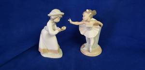lot 6436 image: Lladro NAO #1150 My First Bow Figurine & Lladro NAO #1077 Tender Love Collector Statues - Each missing 1 finger, No Boxes
