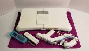 lot 1054 image: Wii Balance Board and 2 Wii Hand Controller wcover and one w gun attachment