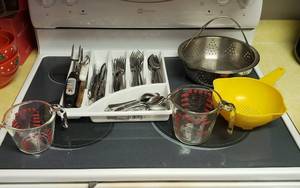 lot 195 image: Silverware, Pyrex Measuring Cups and Strainers