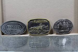 lot 3004 image: Lot of 3 Vintage Belt Buckles Includes a Solid Brass 1976 Heritage American Cowboy, 1986 St. Joseph Catholic Church Wichita KS, & a 1983 Ponca City Conoco - WILL SHIP