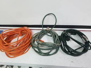 lot 1424 image: One 50 ft extension cord and two 25 ft extension cords