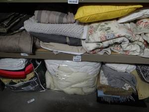 lot 672 image: 2 Shelves of Goods. Mostly Bedding and Pillows.