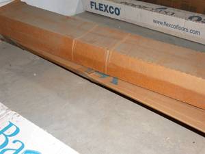 lot 2716 image: FLEXCO 4-in W x 4-ft L Charcoal Thermoplastic Rubber Wall Base, Approx 24 Pieces