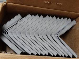 lot 2723 image: FLEXCO Rubber Floor Wall Base Corner Molding, Medium Gray, Approx 30 Pieces