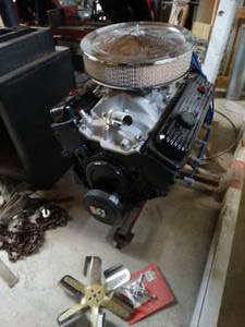 lot 1127 image: GM V8 motor- rebuilt motor- never installed . Appears to be in very good shape &i includes motor stand