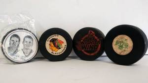 lot 9954 image: 4 Vintage Hockey Pucks Wichita Wind, Chicago Blackhawks, Seattle Totems, & 1997 Souvenir Puck from Burger King