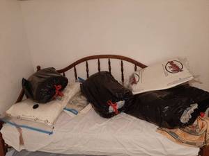 lot 1507 image: All Bedding and Space Bags on Top of Bed