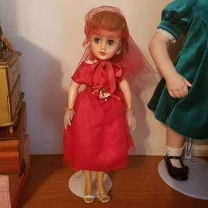 lot 1744 image: doll with red dress on stand