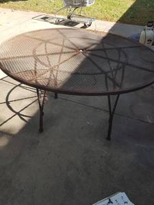 lot 214 image: 54 in steel patio table. needs TLC ( unstable )