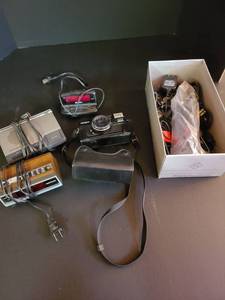 lot 2036 image: Minolta 35 mm camera, alarm clocks and assorted supplies
