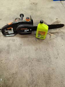 lot 3064 image: Remington electric chainsaw with oil