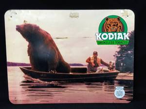 lot 103 image: Vintage Kodiak Smokeless Tobacco Snuff Metal Sign With Bear And Boat