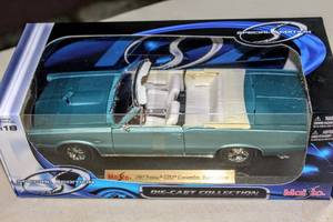 lot 6200 image: Special Edition Maisto 1965 Pontiac GTO Convertible, Hurst Edition #31884 and 1962 Chevrolet Bel Air #30641, Both in Original Sealed Box
