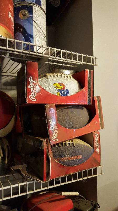 lot 1101 image: (8) Rawlings KU footballs and elect...