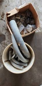lot 6023 image: Bucket of conduit, elbows & metal straps, box of connectors