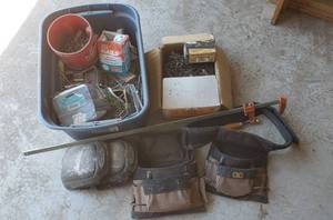 lot 7408 image: Box of 6 x 2 inch drywall screws, Tub of nailsscrews, tool belts, knee pads, bar clamp