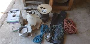 lot 7409 image: Plastic sheeting, Sprayer, rope, dolly, can light, box of Cat 5 cable, spool of cable, drop light, extension cord